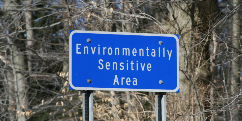 Blue and white sign reading Environmentally sensitive area