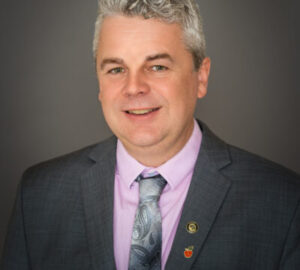 Mayor Silas White wearing a suite and tie with a pink shirt underneath.